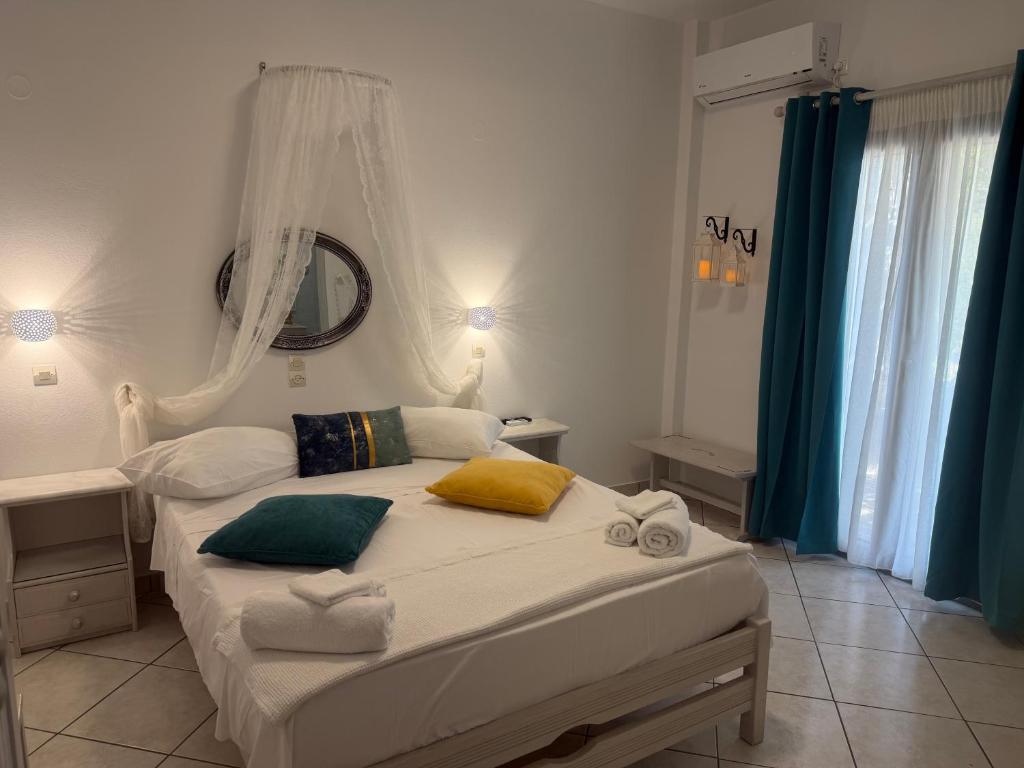 a bedroom with a bed with towels on it at Pension Sofia in Parikia