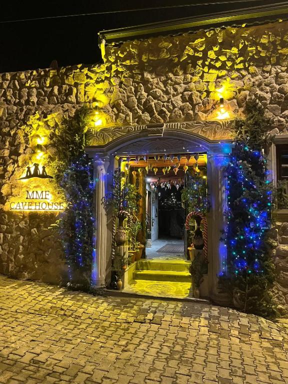an entrance to a building with christmas lights at MMF cave house in Nevşehir