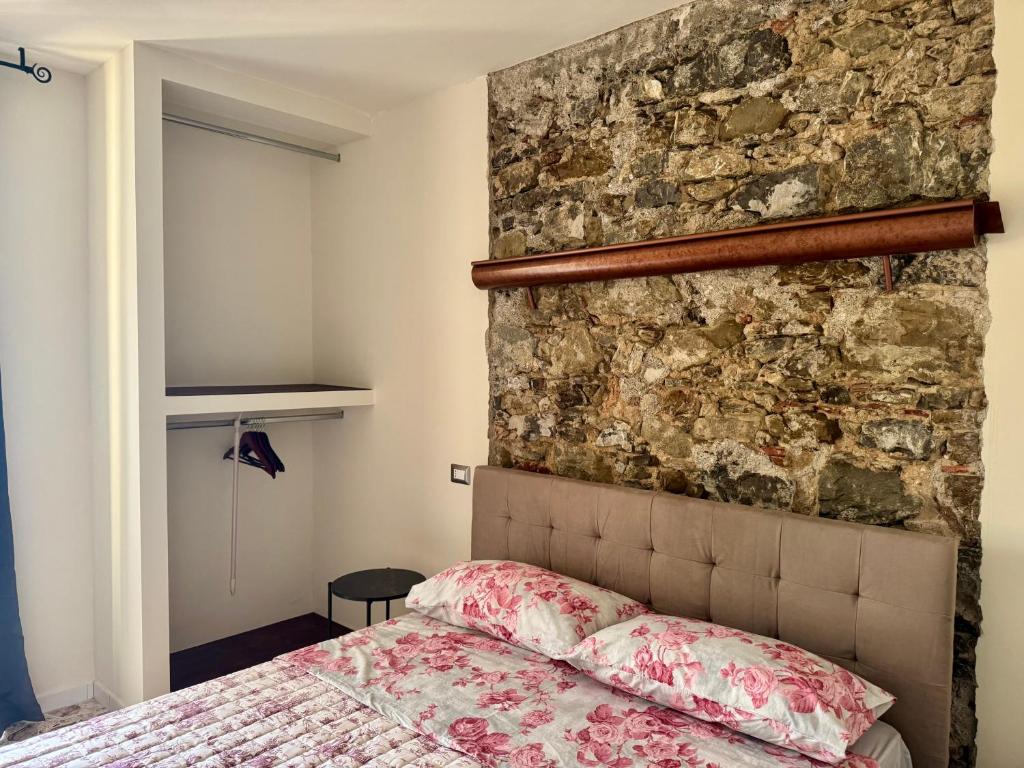 a bedroom with a stone wall and a bed at Residenza 33 in Torchiara