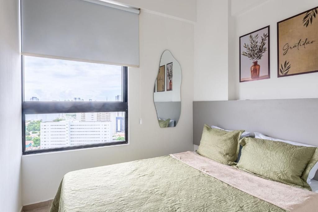 a white bedroom with a bed and a window at Full Apartment with Pool and Gym - M1605 in Recife