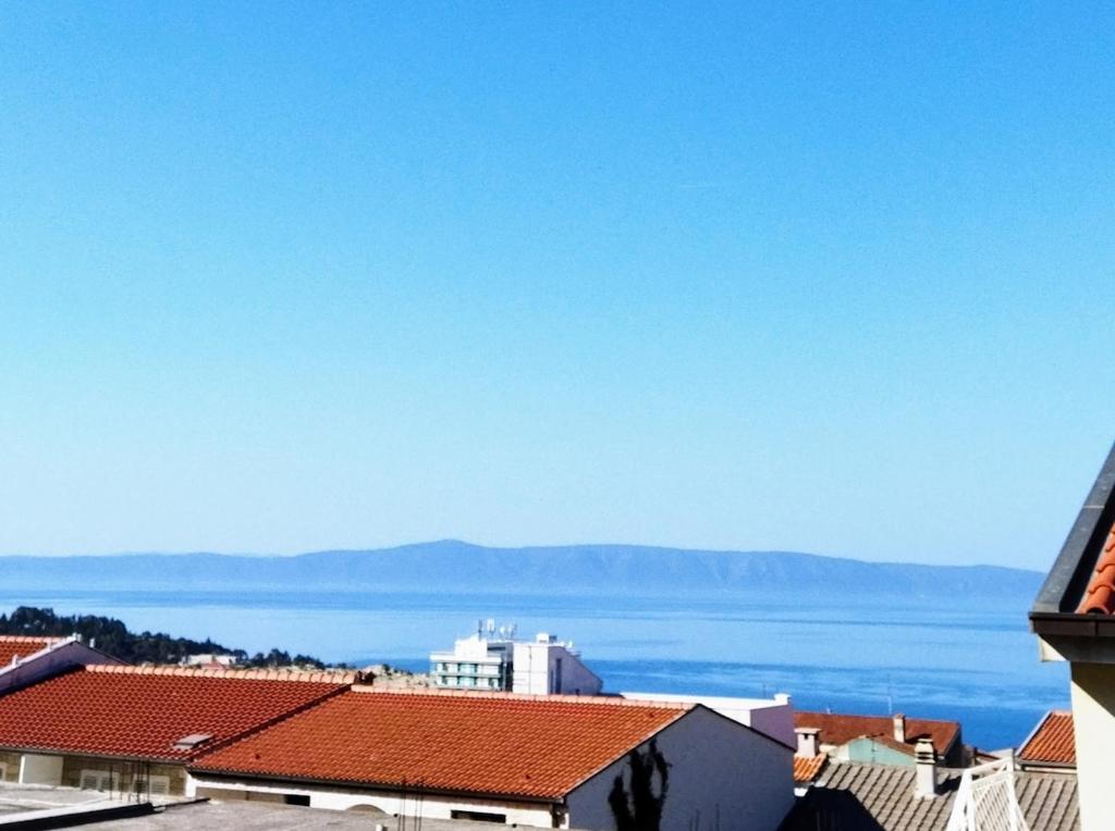a view of the ocean from the roofs of buildings at toni in Makarska