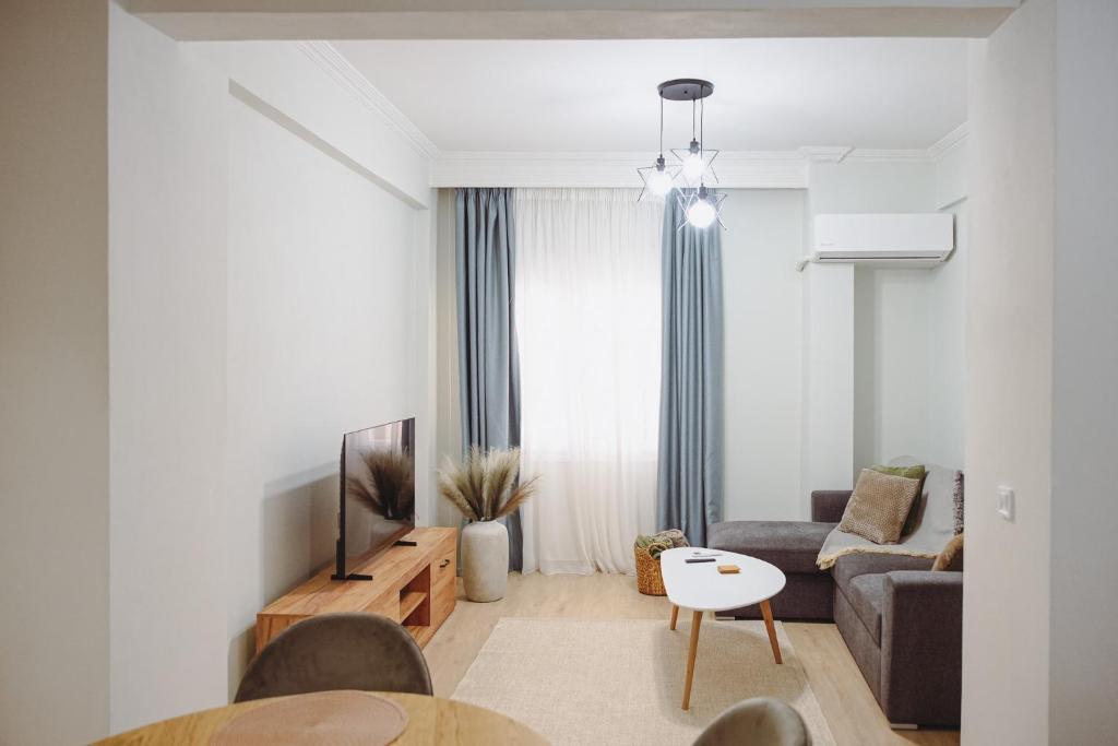 a living room with a couch and a tv at Datidis Urban Nest in Komotini