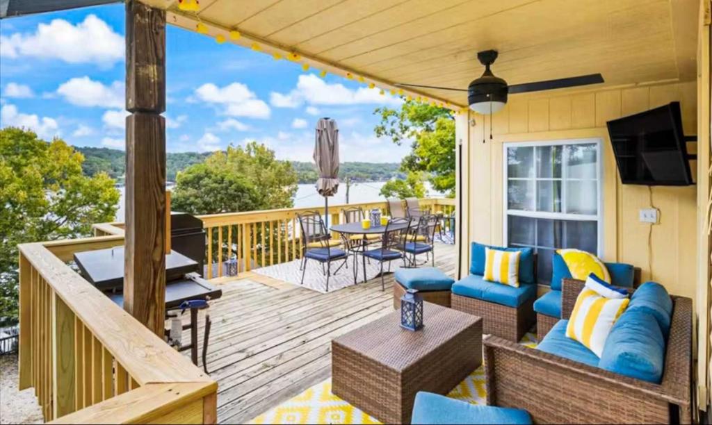 a deck with a television and a table and chairs at The Rubber Duck in Gravois Mills