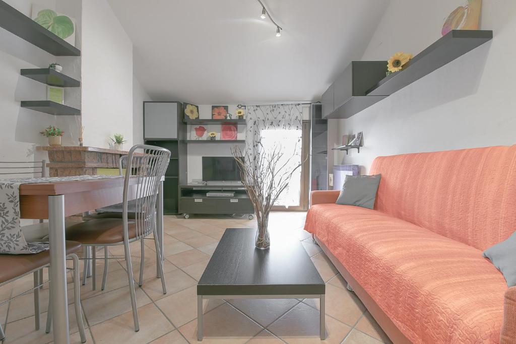 a living room with a couch and a table at Queen Home Funo Centergross in Castel Maggiore