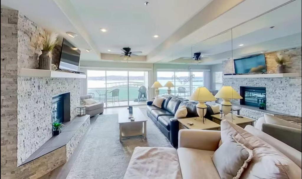 a living room with a couch and a fireplace at Waters Edge in Lake Ozark