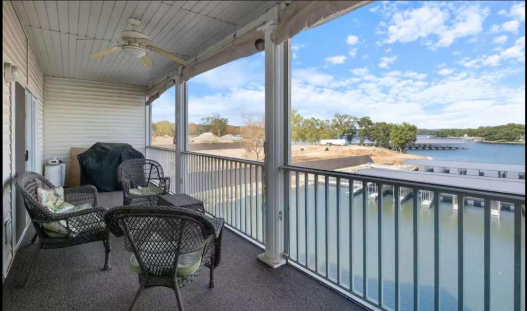 a porch with chairs and a view of the water at Lakeside Lookout in Sunrise Beach