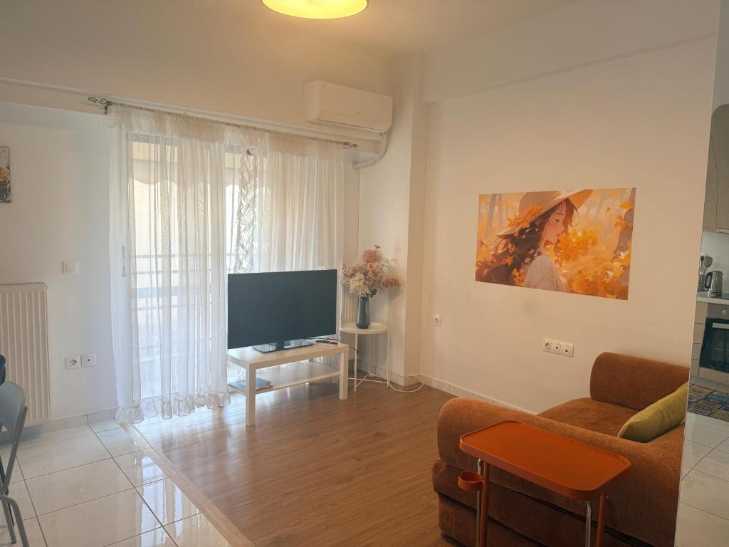 a living room with a couch and a television at Piraeus new hotel in Piraeus