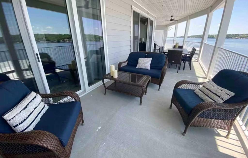 a screened porch with chairs and a table on a house at Lakeview Luxe Penthouse in Rocky Mount