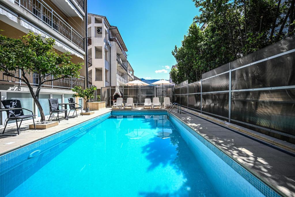 a swimming pool in the middle of a building at Mikuljan Apartments- Free Parking -5 Min by Walk to Beach in Stobreč