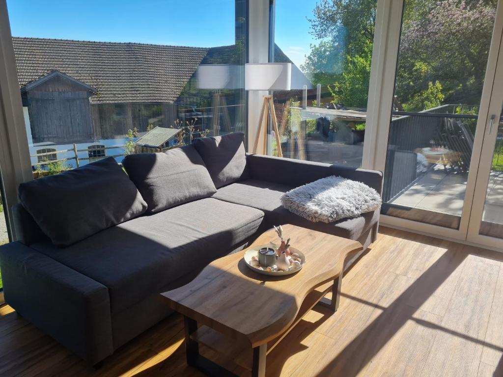 a living room with a couch and a coffee table at 5lakes & nature in Starnberg
