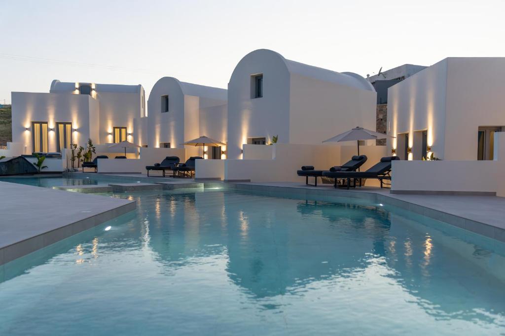 a large swimming pool in front of a building at Maiandros Suites in Karterados