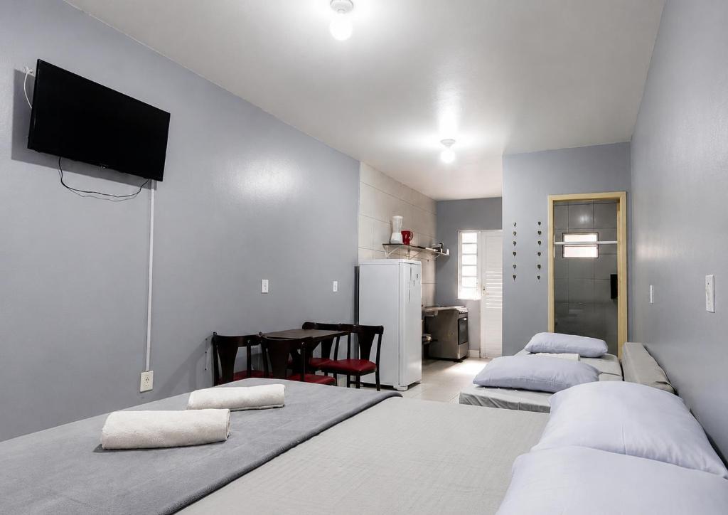 a bedroom with two beds and a table with a tv at Recanto dos Pássaros 306C Até 10x Sem Juros no Cartão Direto com a Propriedade in Itapema
