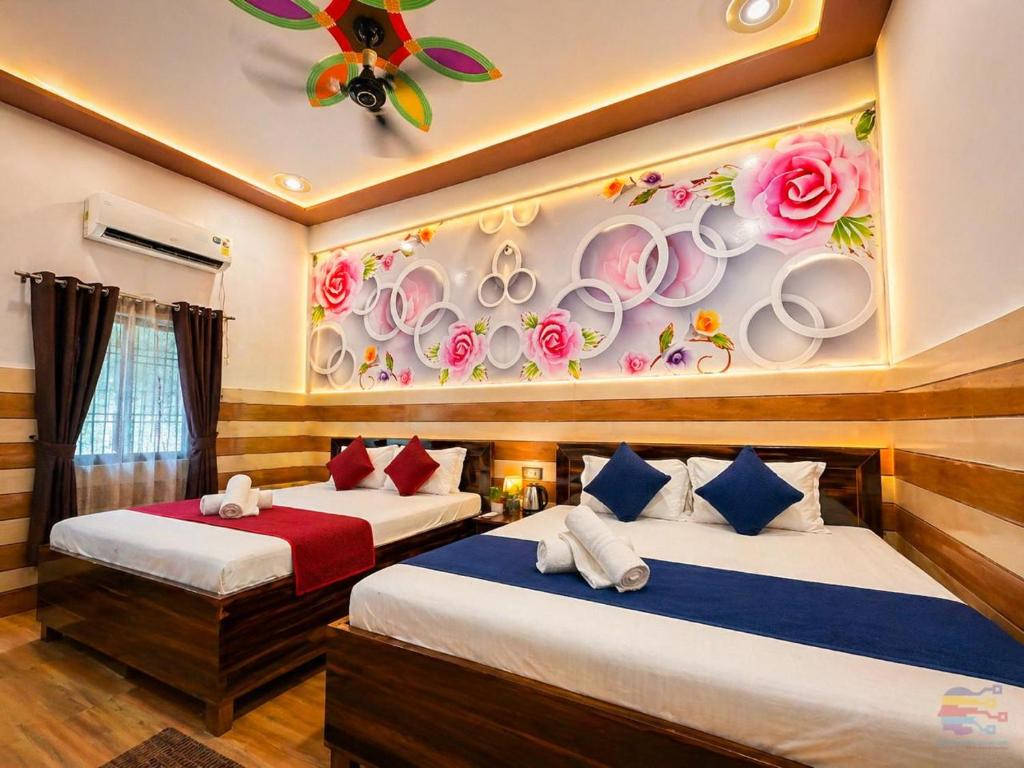 two beds in a room with plates on the wall at K D Dham Hotel- Near Prem Mandir & Iskcon Temple Vrindavan in Vrindāvan