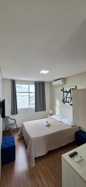 a bedroom with a large bed in a room at Paris Flats Lagoa Santa in Lagoa Santa