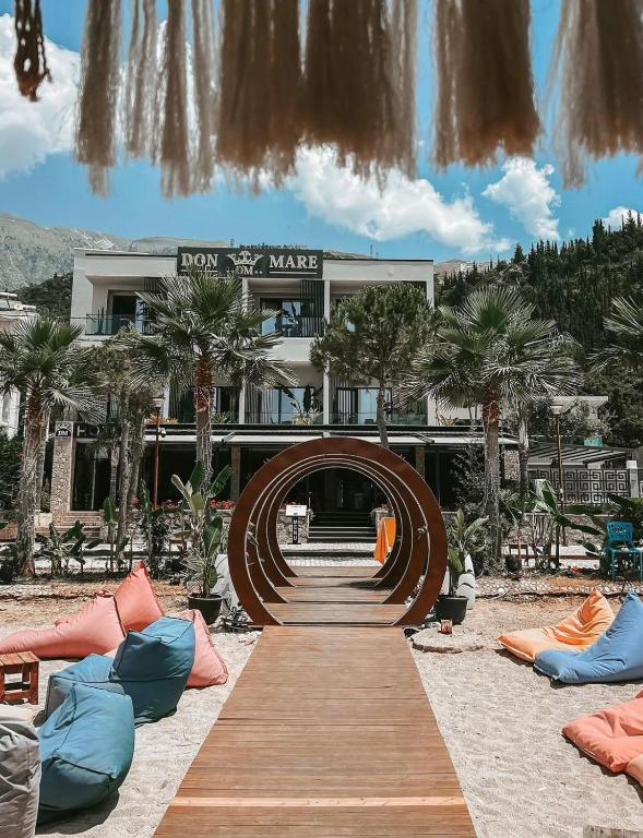a building with a wooden walkway in front of it at Don Mare in Dhërmi