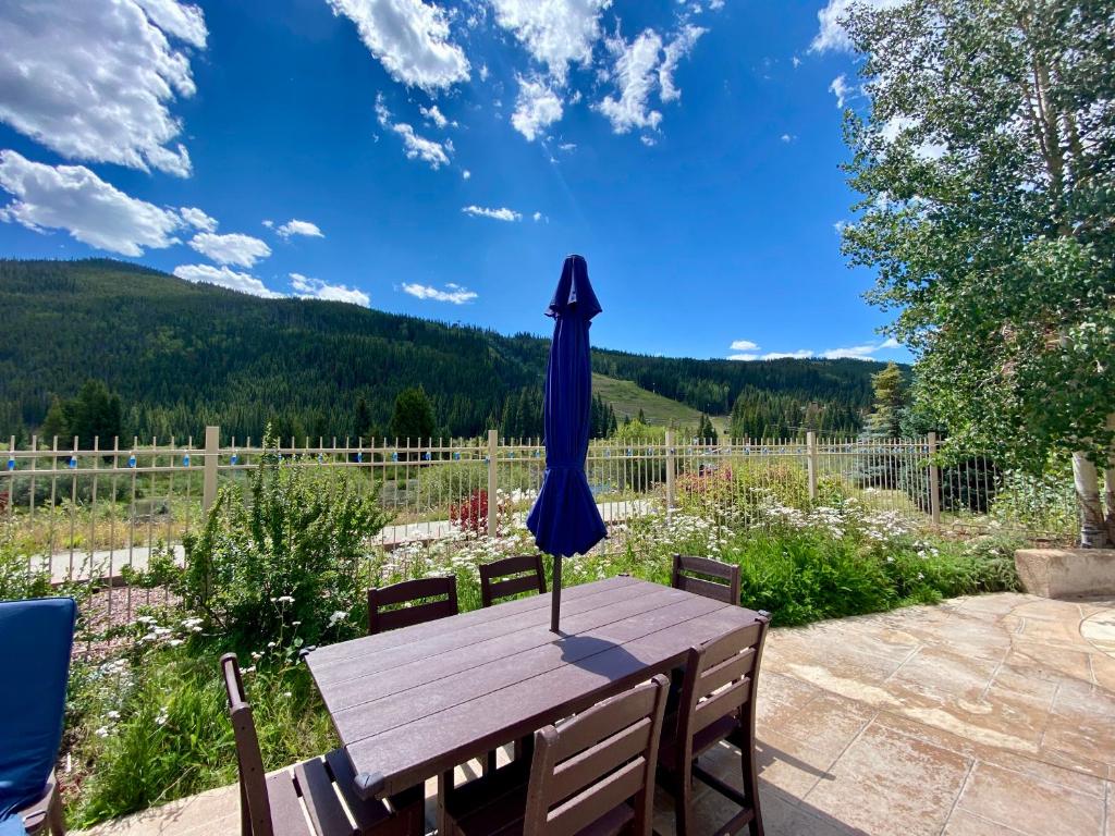 a blue umbrella sitting on top of a wooden table at Red Hawk Lodge 2269 by SummitCove Lodging in Colorado in Keystone