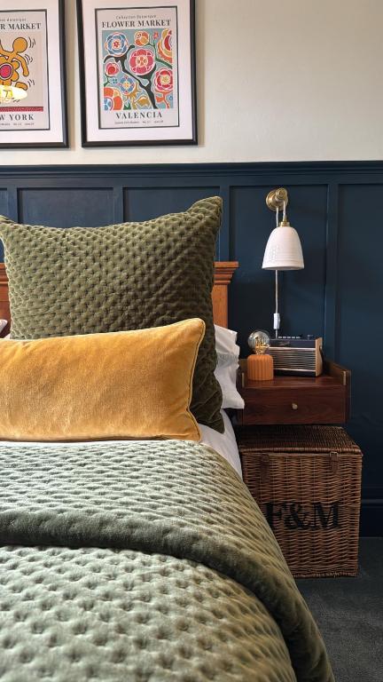 a bedroom with a bed and a table with a lamp at Glenesk No 1 , Woodhall Spa in Woodhall Spa