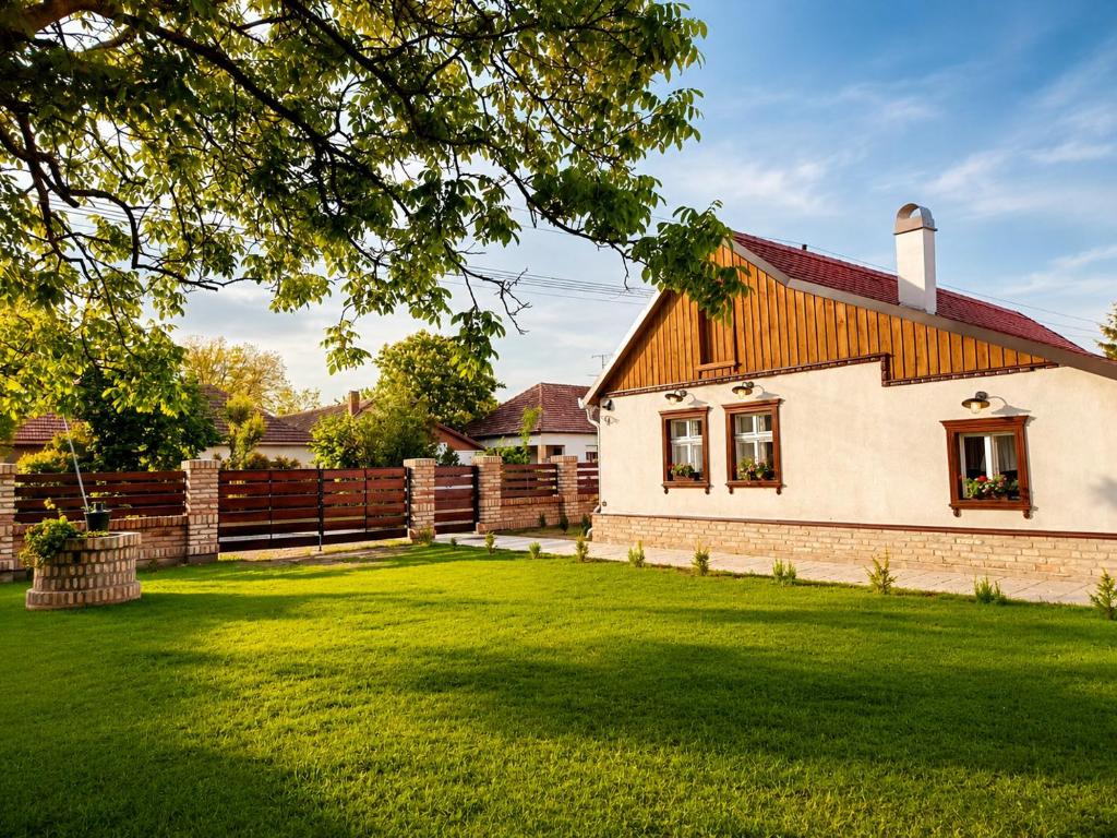 a white house with a fence and a grass yard at Salaš 1860 - Palić in Palić
