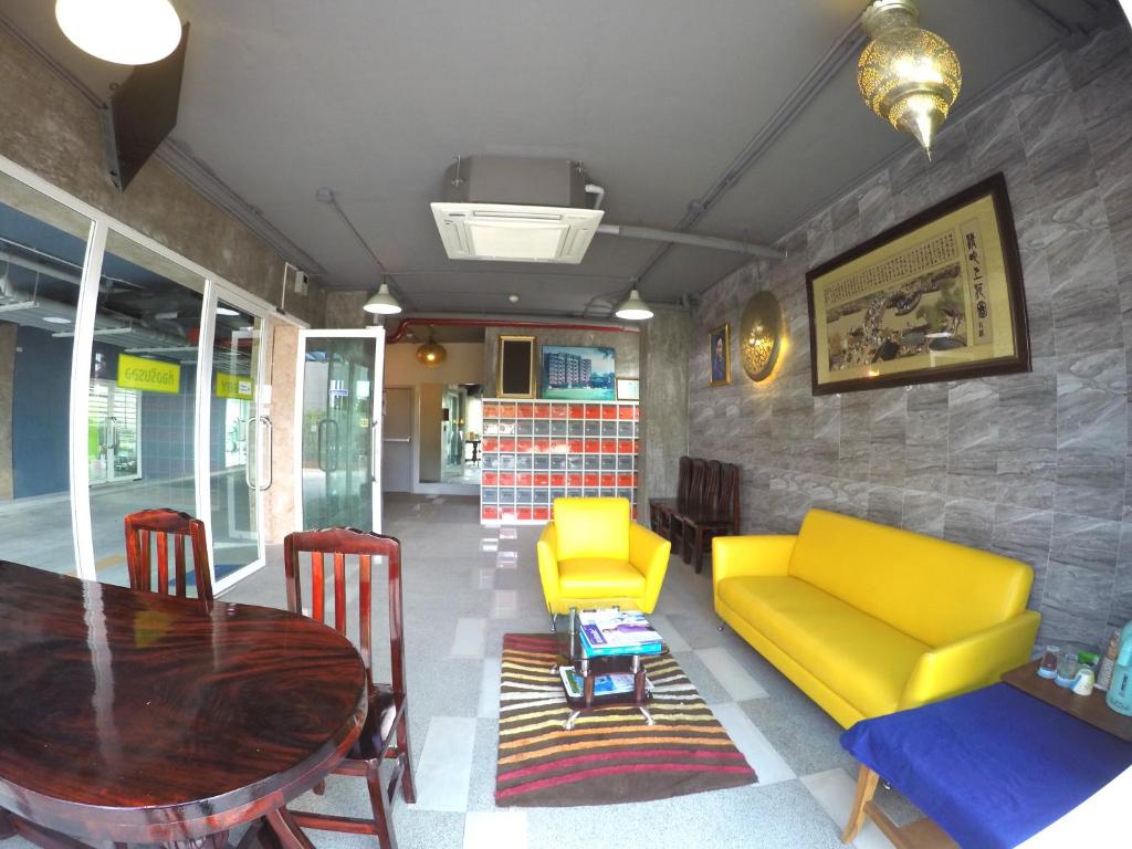 a dining room with a table and yellow chairs at Me Condo by SN in Rayong