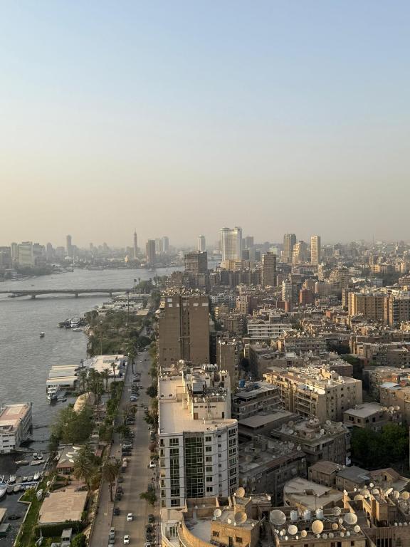 an aerial view of a city with a river and buildings at Nile Royale Hotel in Cairo