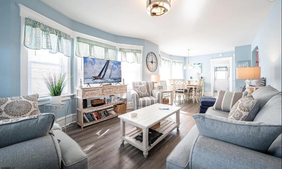 a living room with two couches and a table at Beach Block Ocean Views steps from the boardwalk in Ocean City