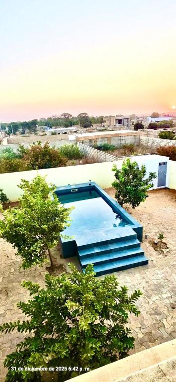 a large swimming pool in the middle of a field at Tata Khane in Ngaring