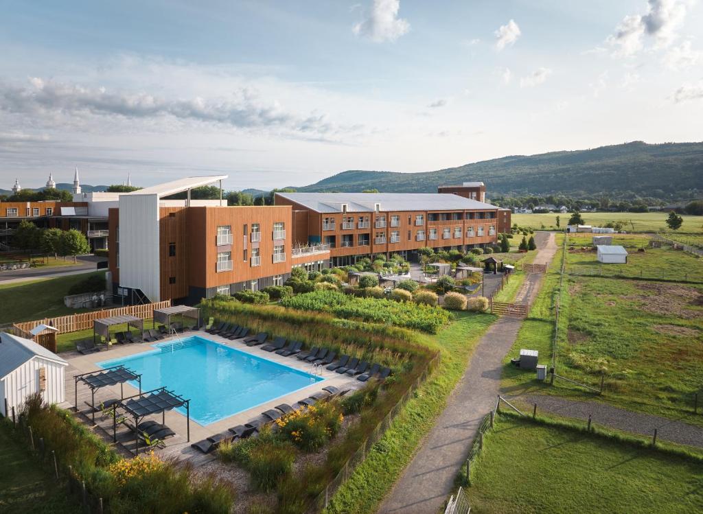 an aerial view of a resort with a swimming pool at Hôtel & Spa Le Germain Charlevoix in Baie-Saint-Paul