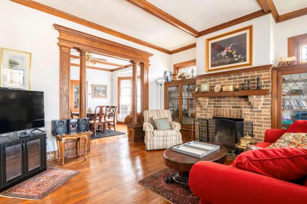 a living room with red furniture and a fireplace at Cozy Cape Cod Bungalow King Queen WD Full Kitchen Wifi Desk in York