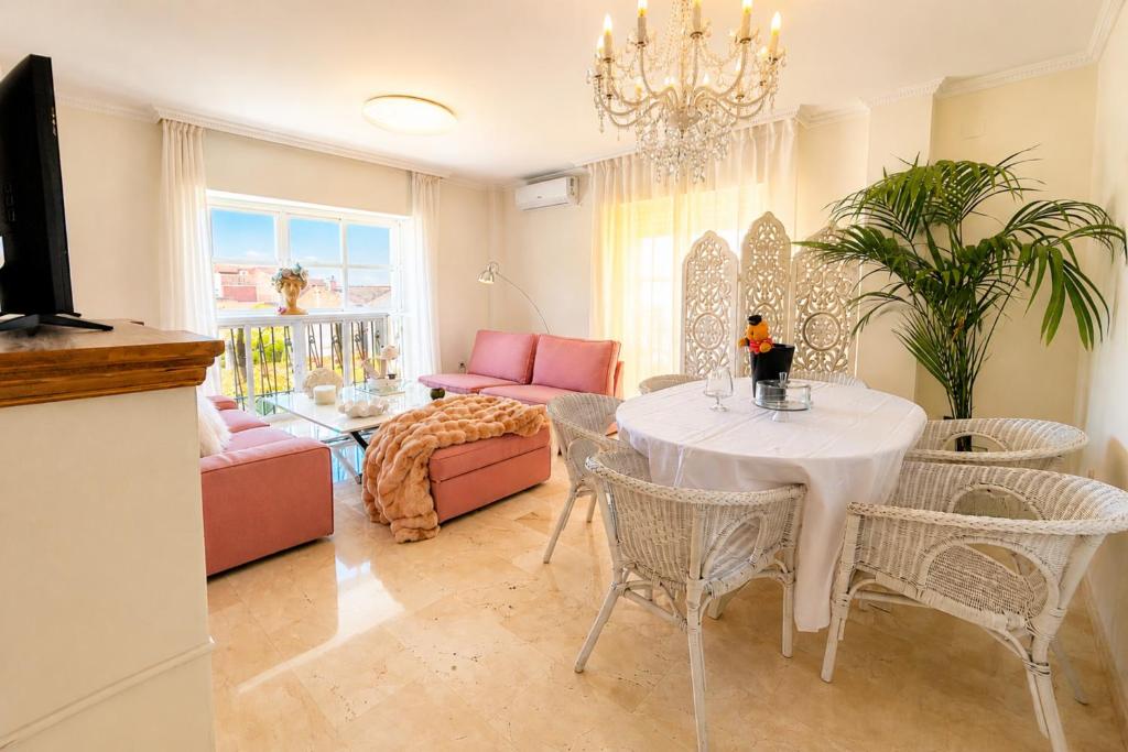 a living room with a table and chairs at Apartment with private parking included - Granada in La Zubia