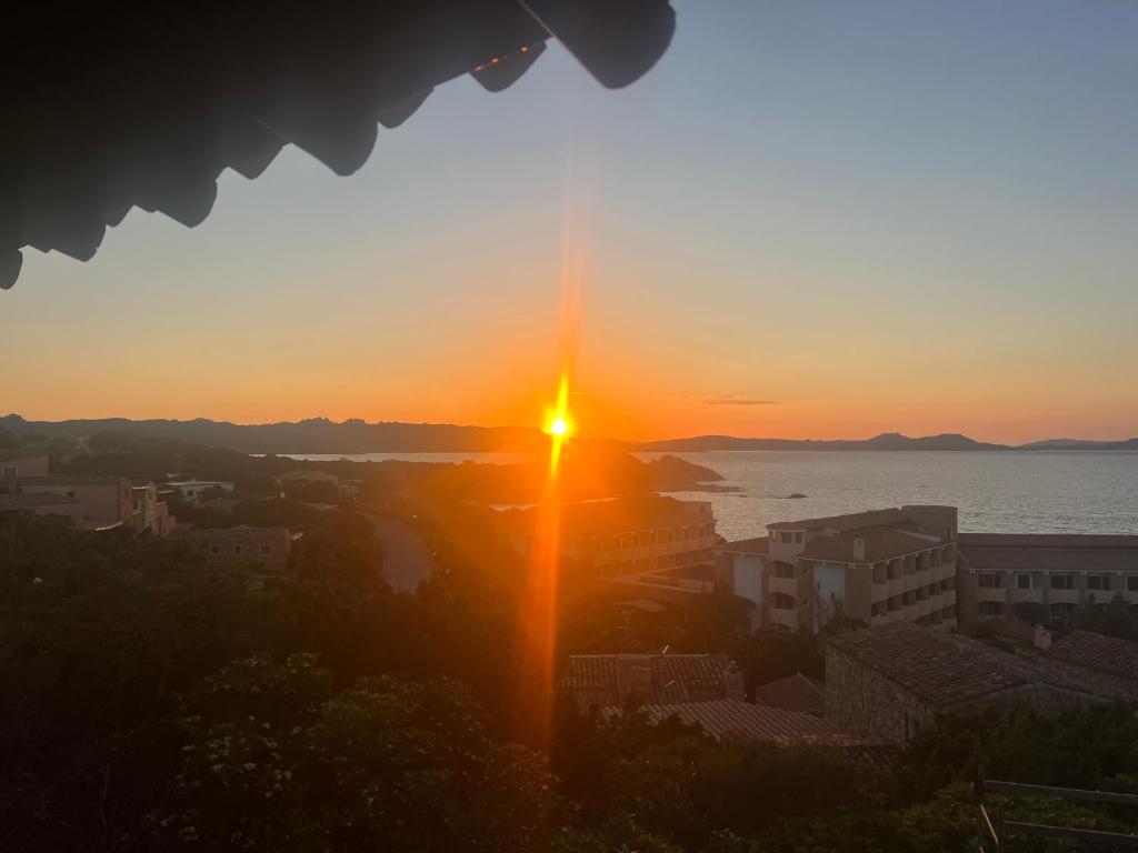 a view of the sunset from a building at Seafront wow appartamento Baja Sardinia in Baja Sardinia
