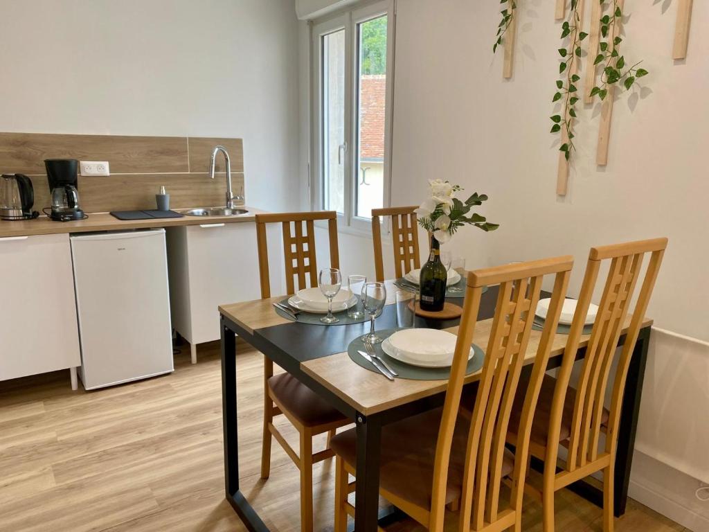 a kitchen and dining room with a table and chairs at Jasmin in Saint-Aignan
