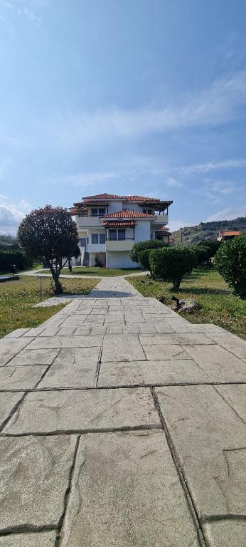 a stone walkway in front of a house at 5 Suites Αγιόκαμπος Αγίας in Agiokampos