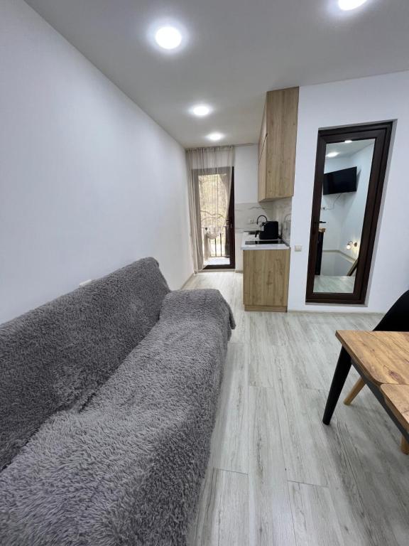 a living room with a couch and a table at Duplex Vakhrama in Abastumani