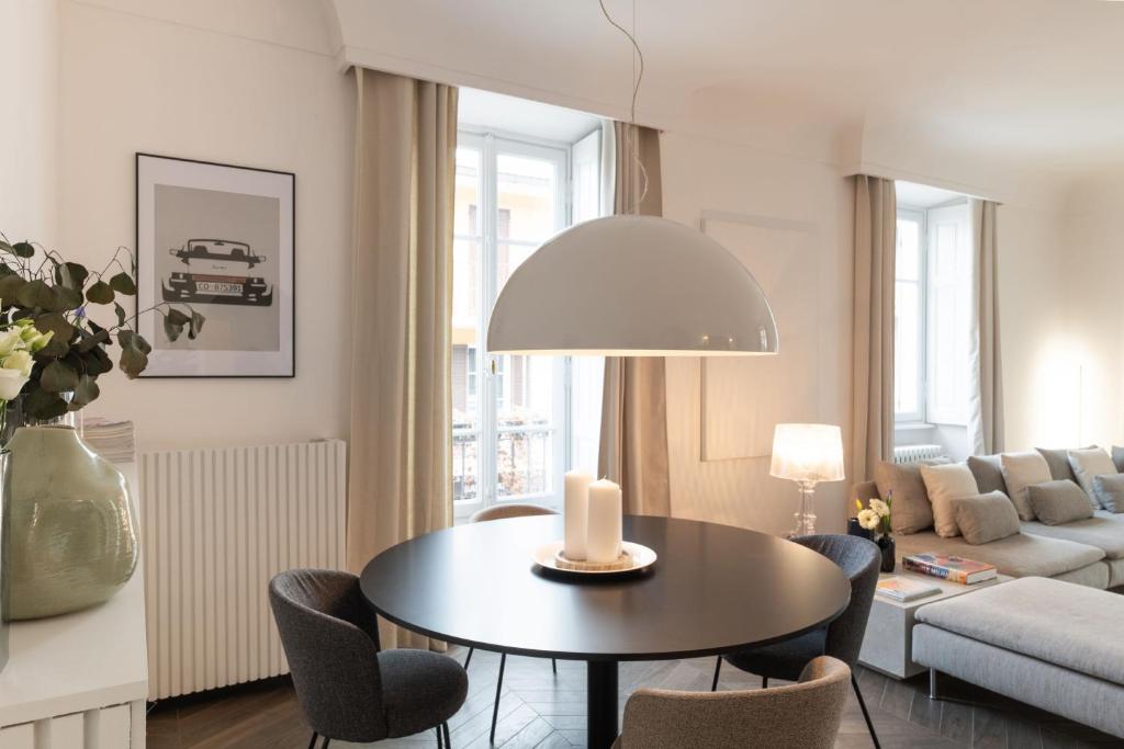 a living room with a table and a couch at Uno - Via Loveno, Menaggio by LoveComo in Menaggio