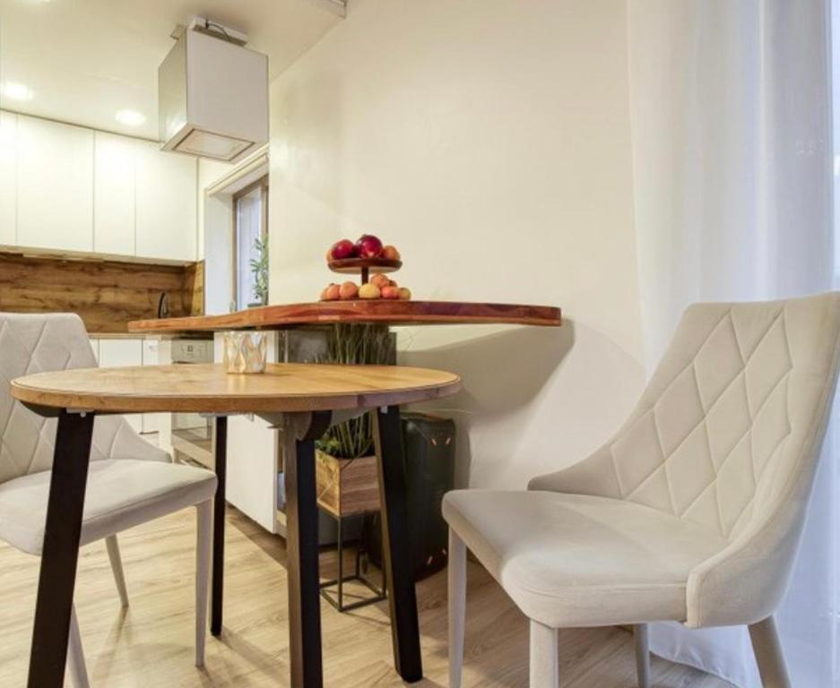 a dining room with a table and two chairs at Bebro namai in Vilnius