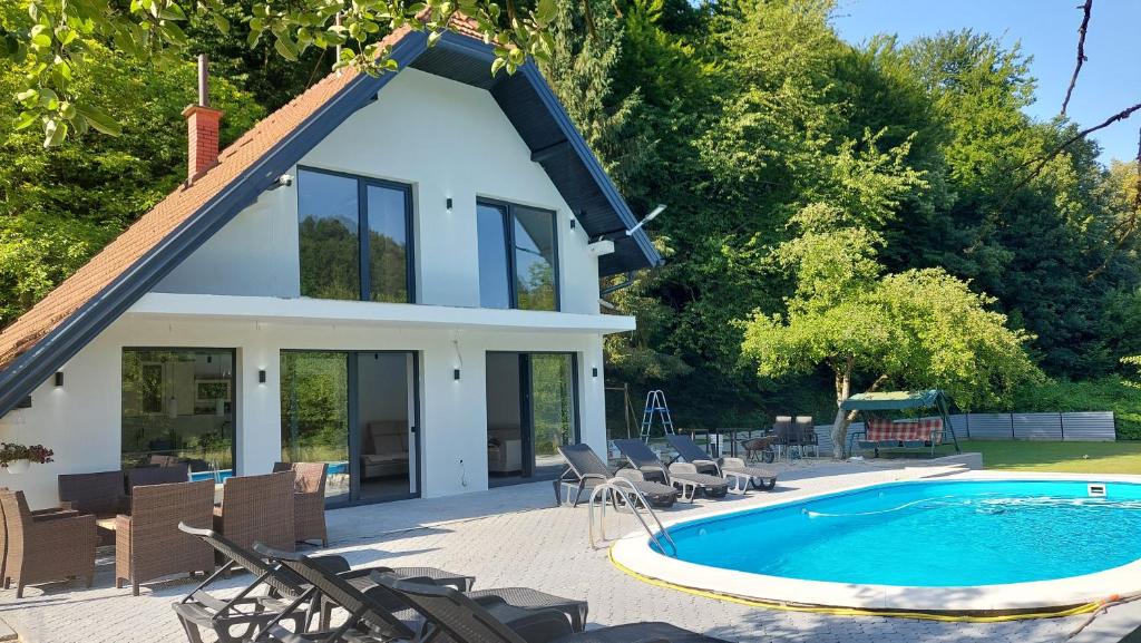 a house with a swimming pool in front of a house at Kuca za odmor Moj Mir in Kalesija