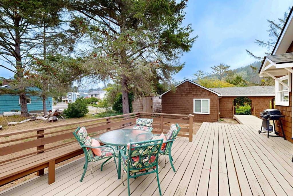 a patio with a table and chairs on a wooden deck at 2nd Tee at Neskowin Village in Neskowin