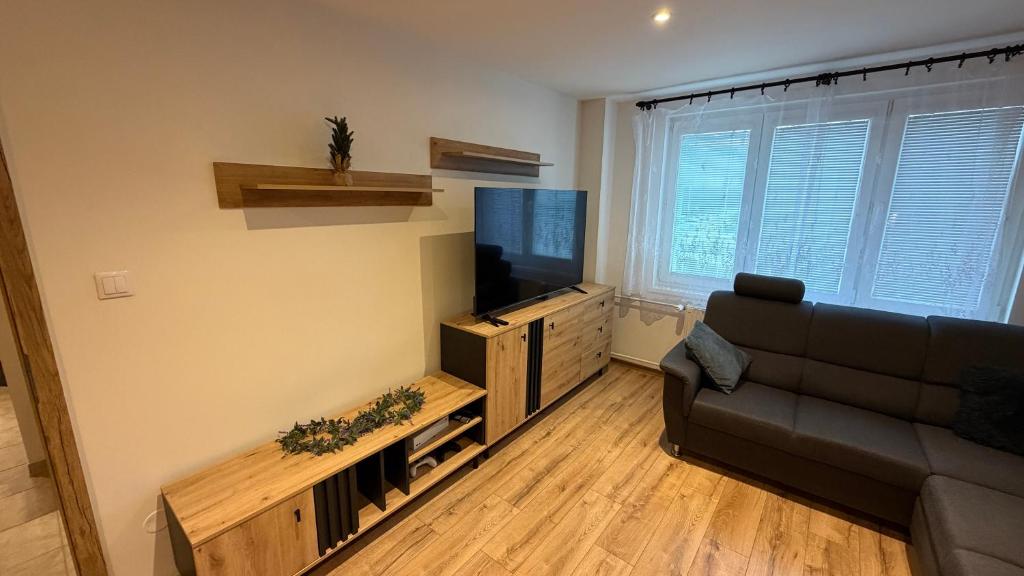 a living room with a couch and a flat screen tv at Rondel in Žilina