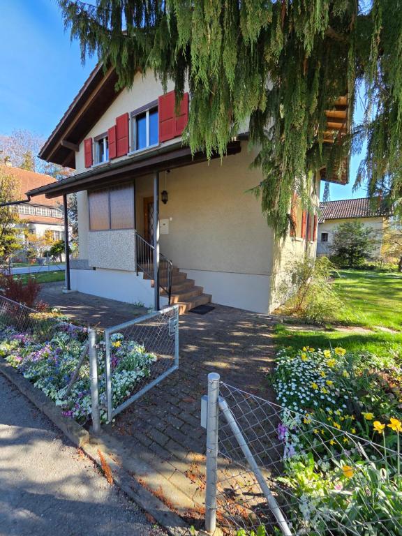 a house with a fence in front of it at Swiss Chalet direkt am Thunersee in Thun