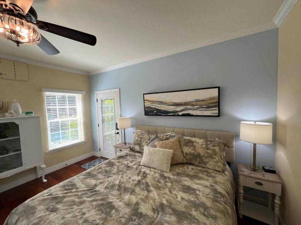 a bedroom with a large bed and two lamps at Luxury Private Poolside Suite in Napa