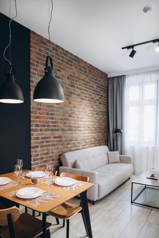 a living room with a table and a couch at Apartament Centrum Żywiec - PILSKO in Żywiec