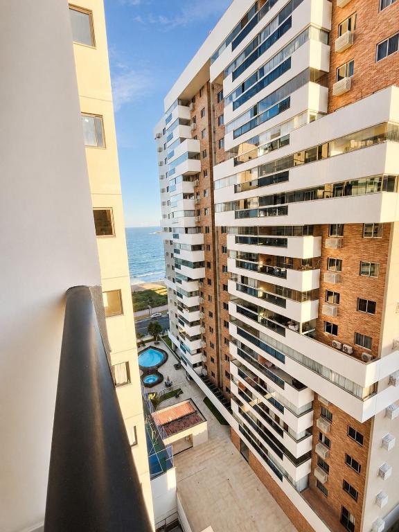 an apartment balcony with a view of the ocean at SkyHero Apê in Vila Velha