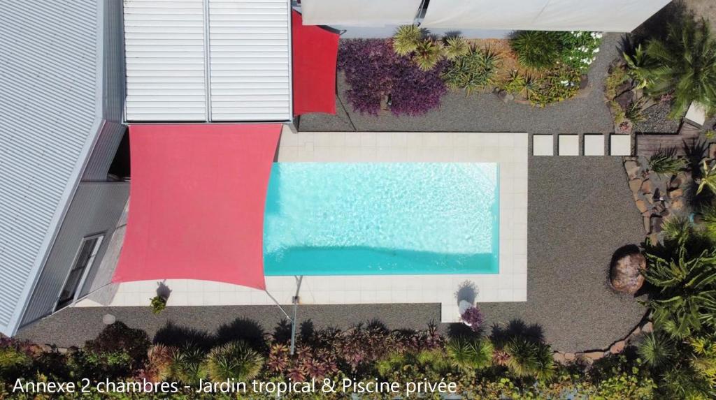 an overhead view of a swimming pool next to a house at Villa Coco Cannelle in Deshaies