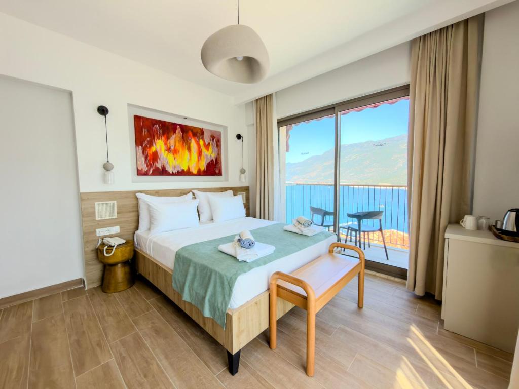 a hotel room with a bed and a large window at Adasya Hotel in Kaş