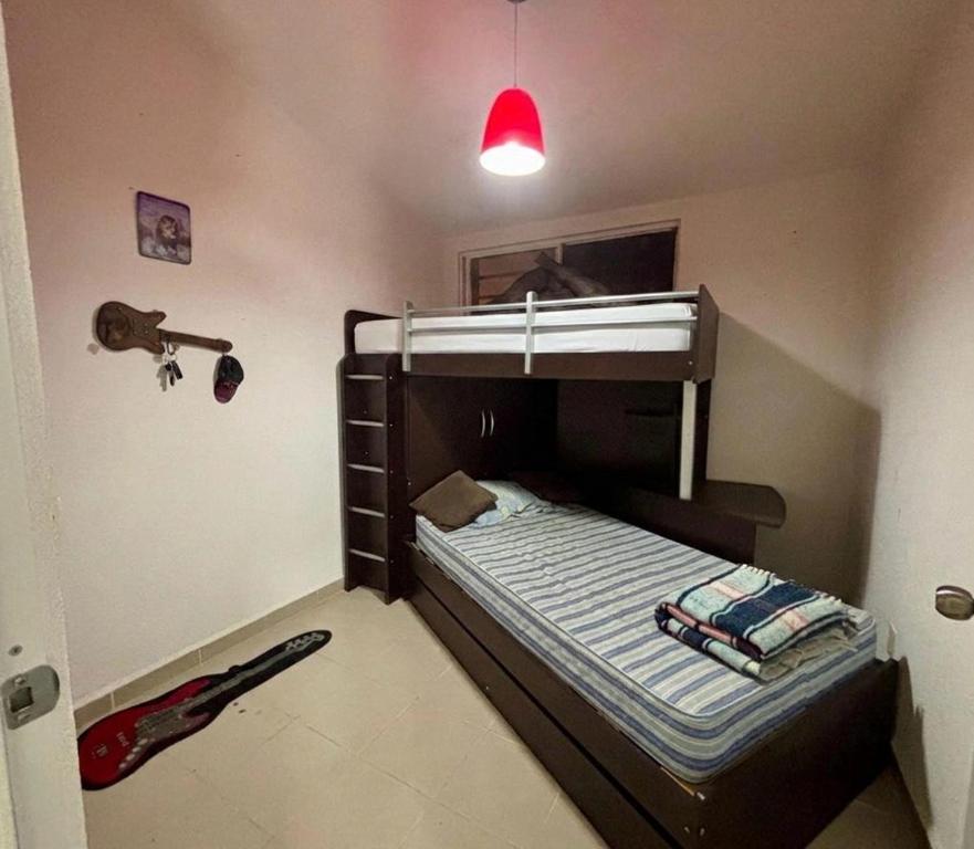 a small bedroom with a bunk bed with a flashlight at Casa Real Santa Fe Cuernavaca in Atlacholoaya