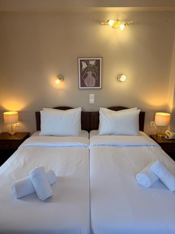two beds in a bedroom with towels on them at Hotel Lemnos in Myrina