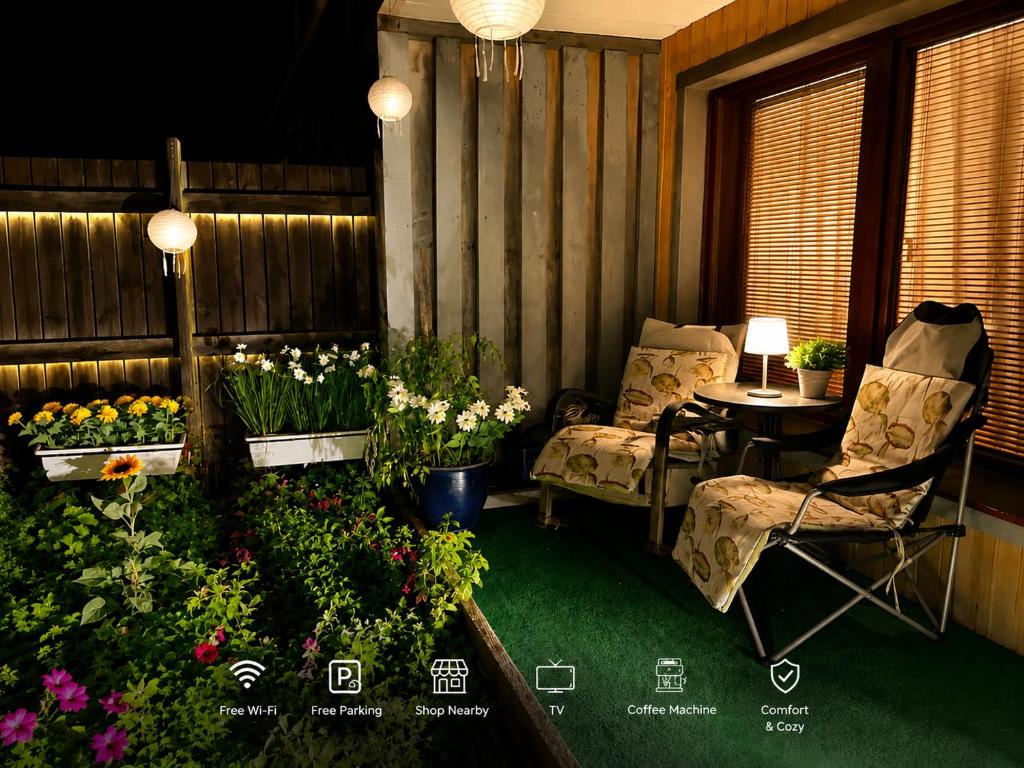 a porch with a table and chairs and flowers at Färösund Sommar in Fårösund