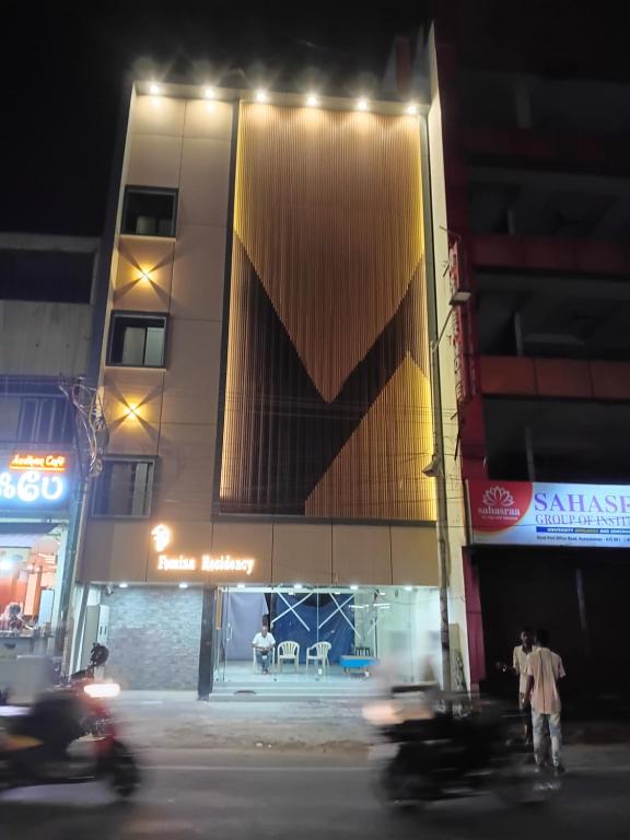 a building with lights on the side of a street at Femina Residency in Kumbakonam