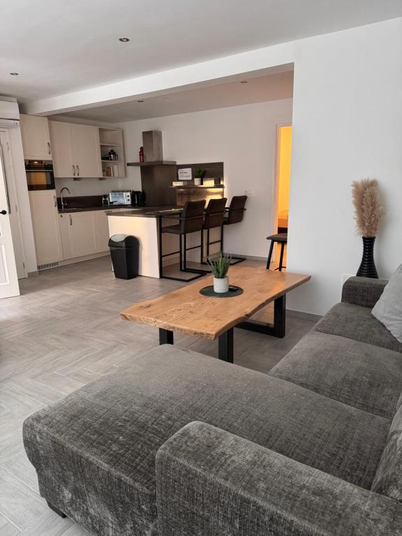a living room with a couch and a table at Smile home, Zaanse schans and Amsterdam Appartements in Wormerveer