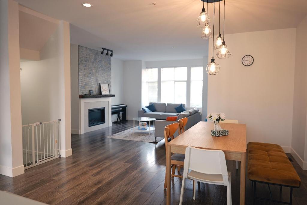 a kitchen and living room with a table and a couch at Modern 3 bedroom duplex home in Langley in Langley